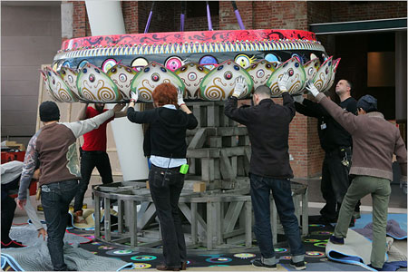 Workers assemble Mr. Pointy, a large-scale sculpture by Takashi Murakami